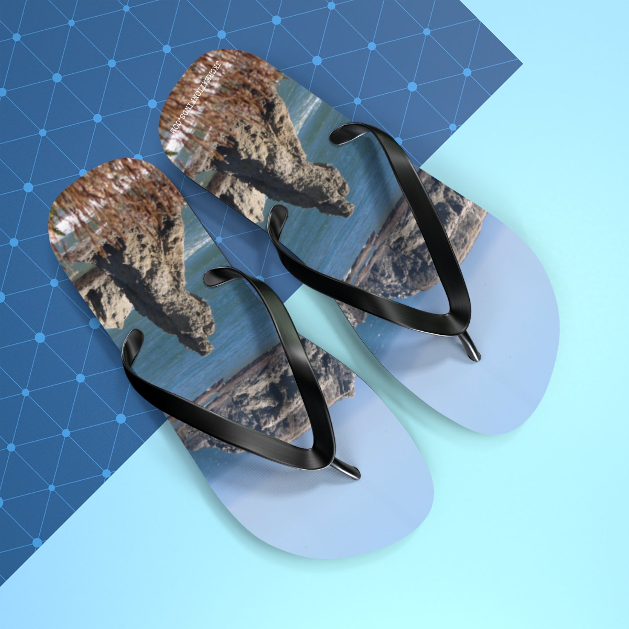 Flip-flops with a rocky coastal landscape print.