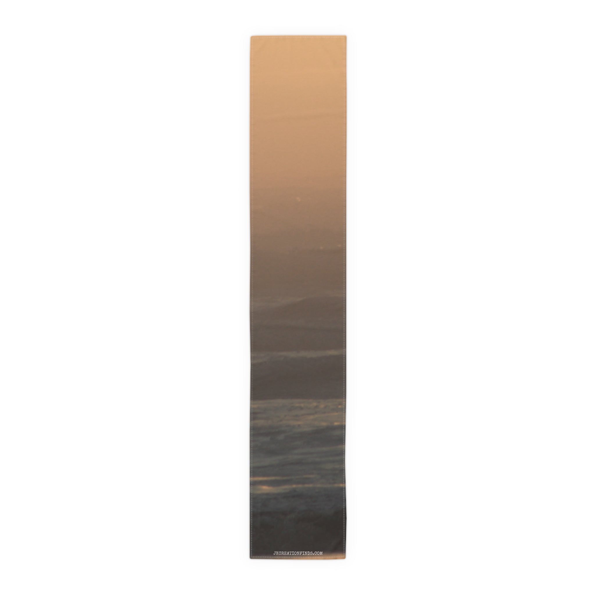 Table runner with abstract ocean sunset waves and a small website address.