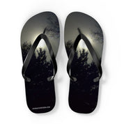 Flip-flops with a dark forest and moonlight scene on the soles.
