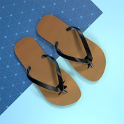 Brown flip-flops with black straps on a blue and light blue background.