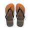 Flip-flops with a sunset ocean wave design on the soles.