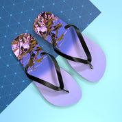 Purple flip-flops with a beach and leafy branch scene on the soles.