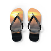 Flip-flops with a sunset ocean scene on the soles.