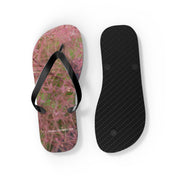 Flip-flops with pink flower pattern and black straps, white background.