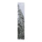 Tall snow-covered evergreen tree against a white sky.