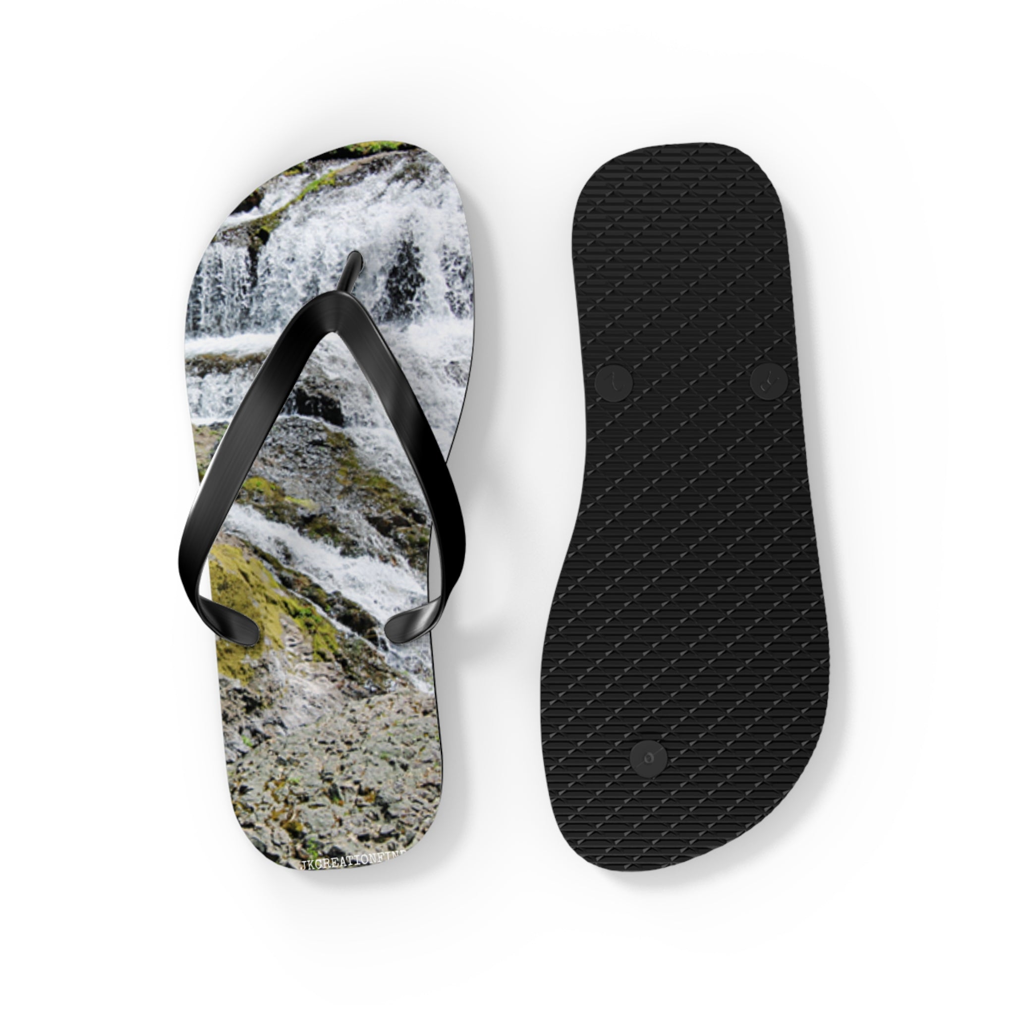 Black flip-flops with a waterfall landscape print on one sole.