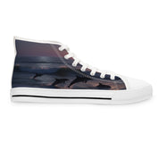White high-top sneaker with leaping dolphins and ocean waves on the side.