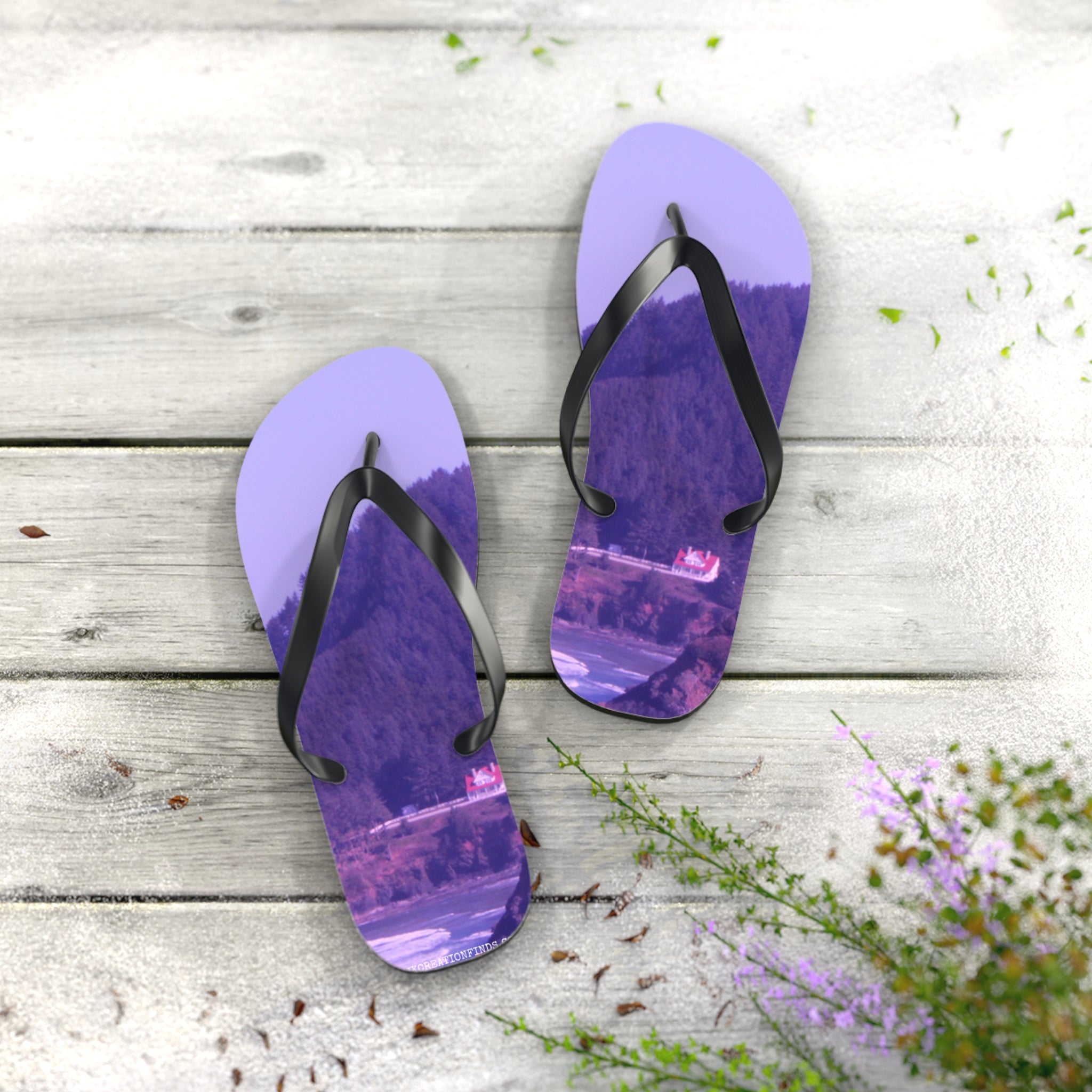 Purple flip-flops with a scenic mountain and house landscape printed on soles.