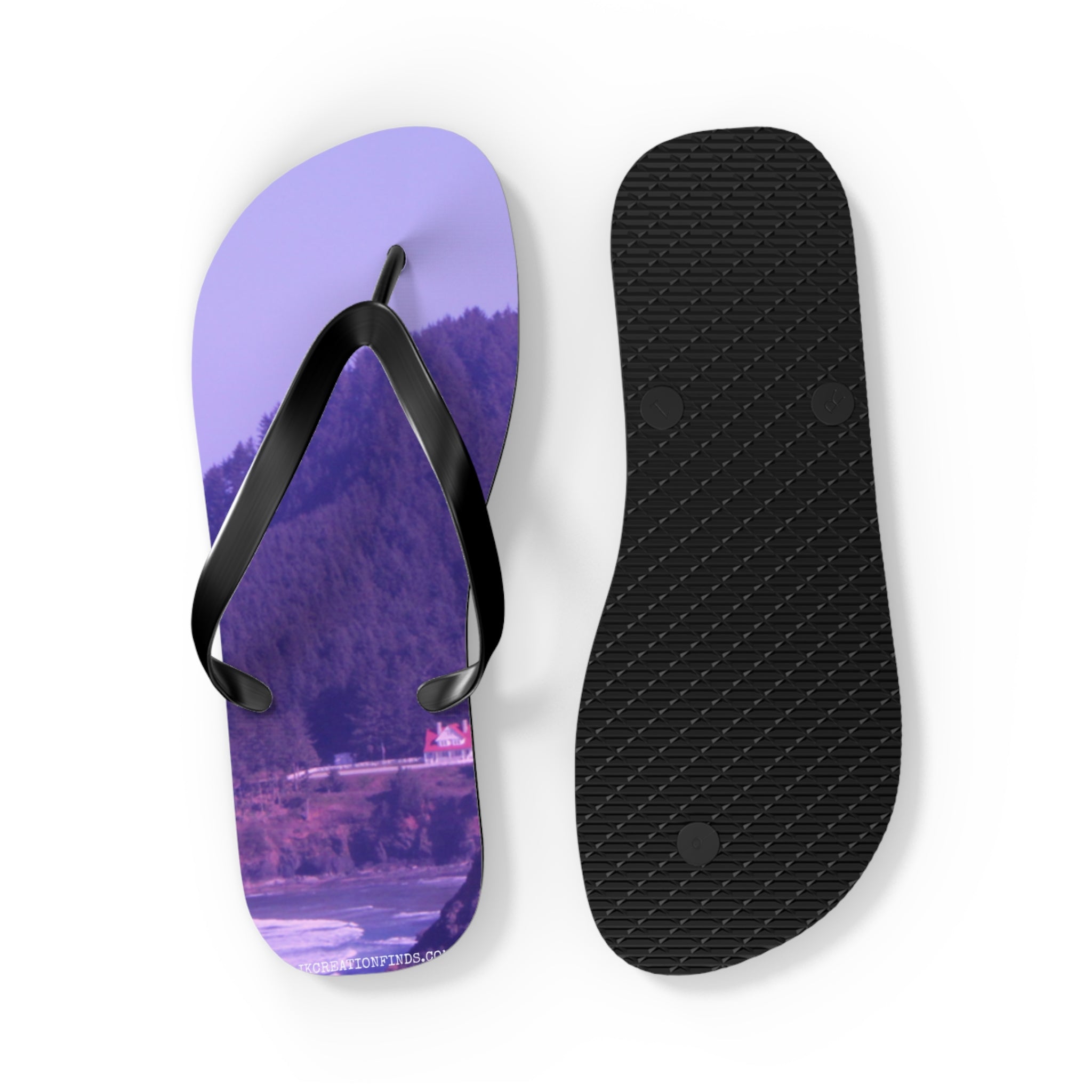 Purple flip-flops with a coastal landscape scene on one sole.
