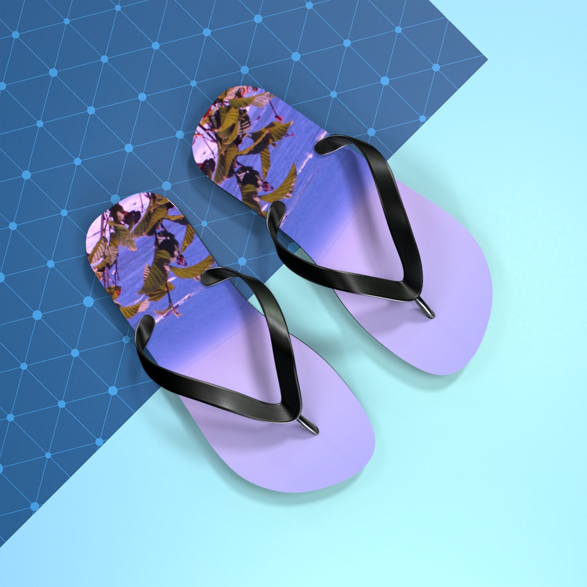 Purple flip-flops with a beach scene on the soles on a blue background.