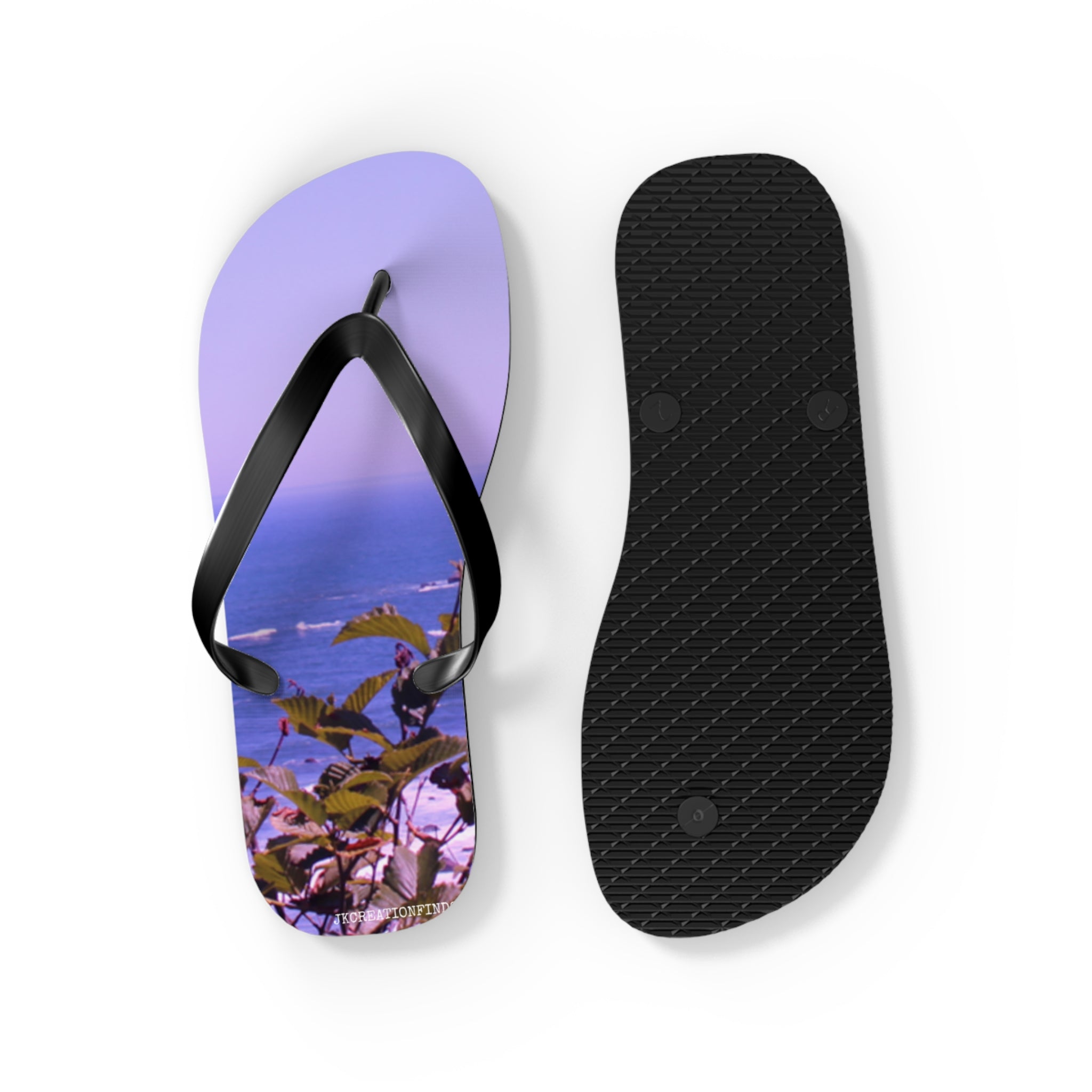 Flip-flops with a seaside landscape design on one sandal.
