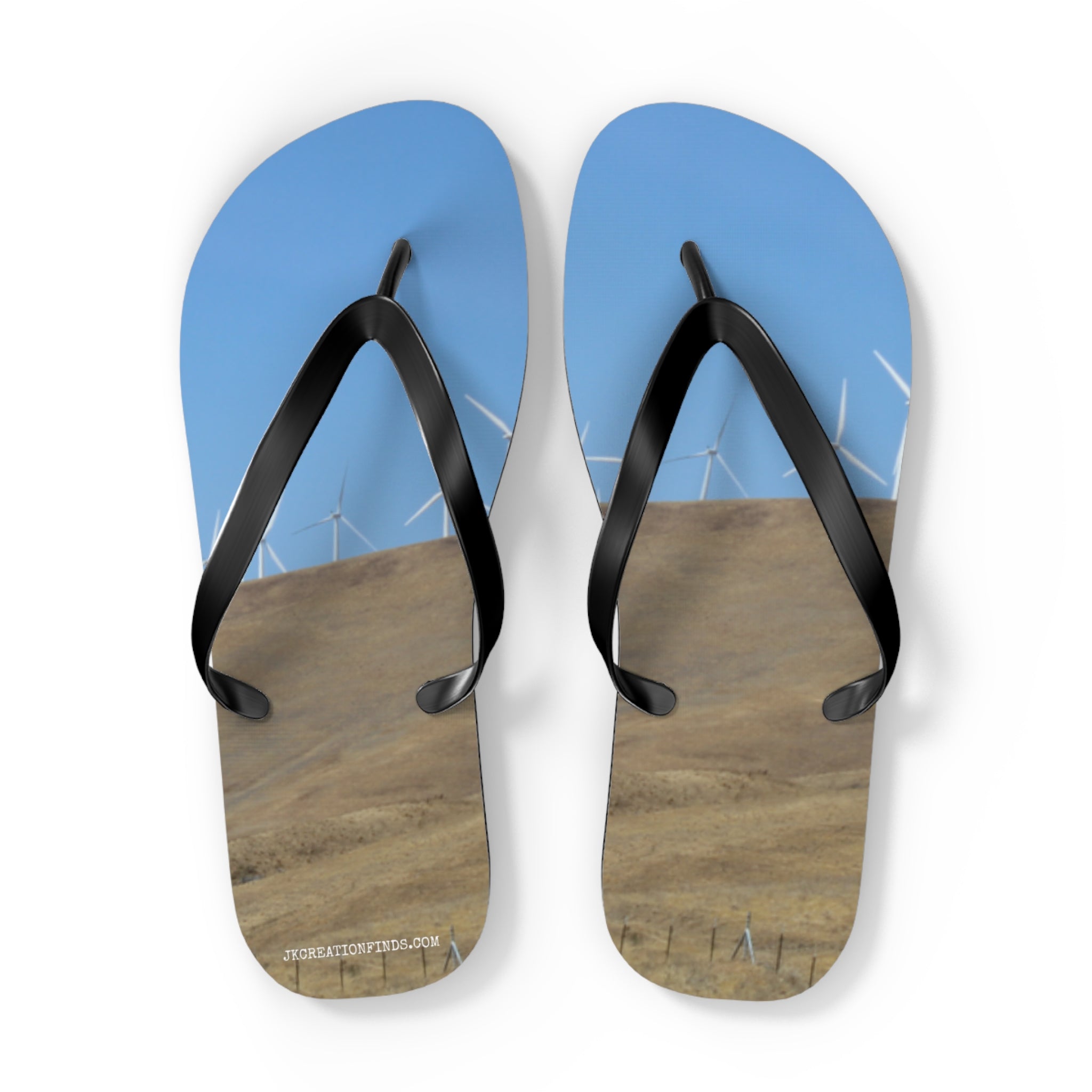 Flip-flops with a landscape of hills and wind turbines under a blue sky.