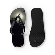 Flip-flops with a moonlit forest scene on the left strap and textured sole on the right.